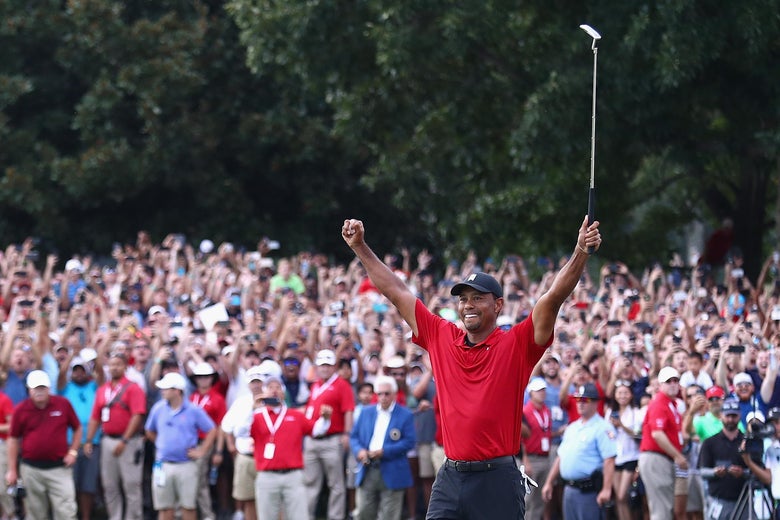 Tiger Woods celebrates making a par on the 18th green to win the Tour Championship at East Lake Golf Club on September 23, 2018 in Atlanta, Georgia.